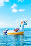 yellow and blue inflatable duck on blue sea under blue sky during daytime
