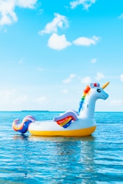 yellow and blue inflatable duck on blue sea under blue sky during daytime
