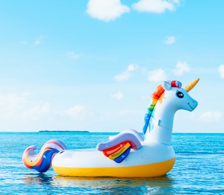 yellow and blue inflatable duck on blue sea under blue sky during daytime