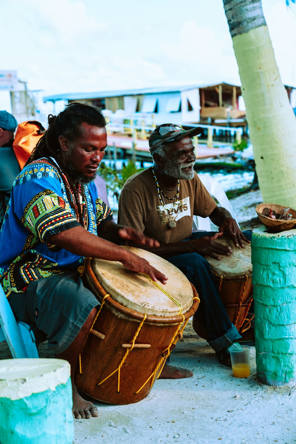 man in brown shirt playing drum