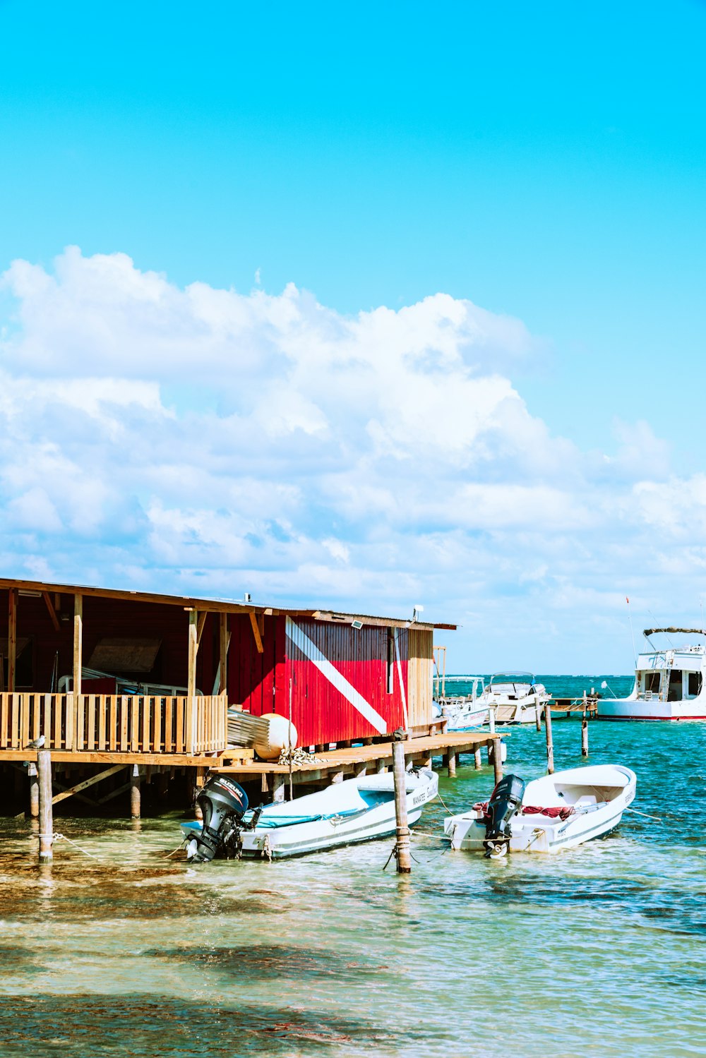 brown wooden house on sea dock during daytime