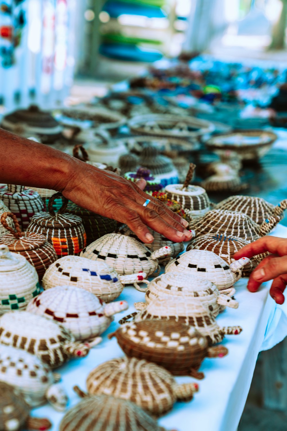 person holding white and brown hat