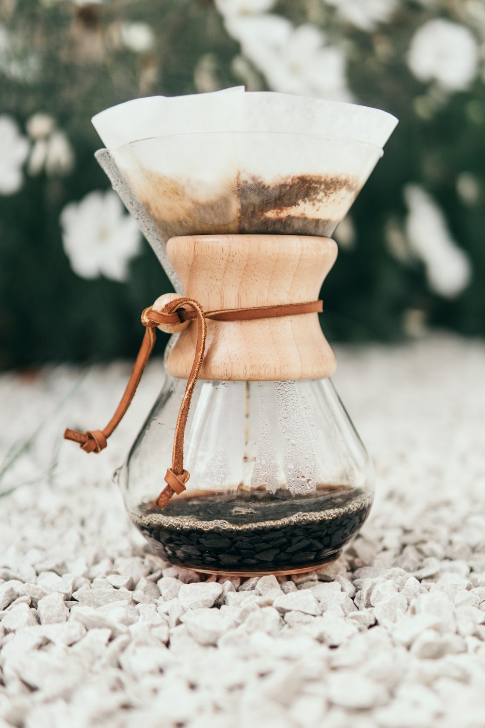 brown ceramic vase on white sand