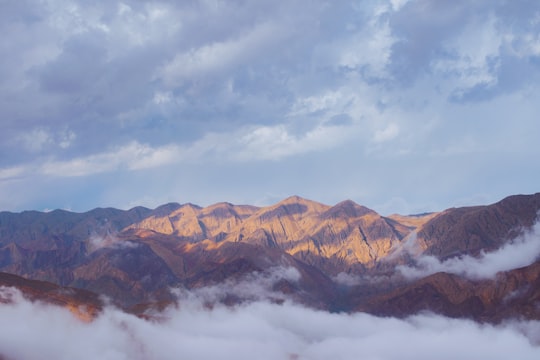 brown mountains under white clouds during daytime in Khorasan Razavi Iran