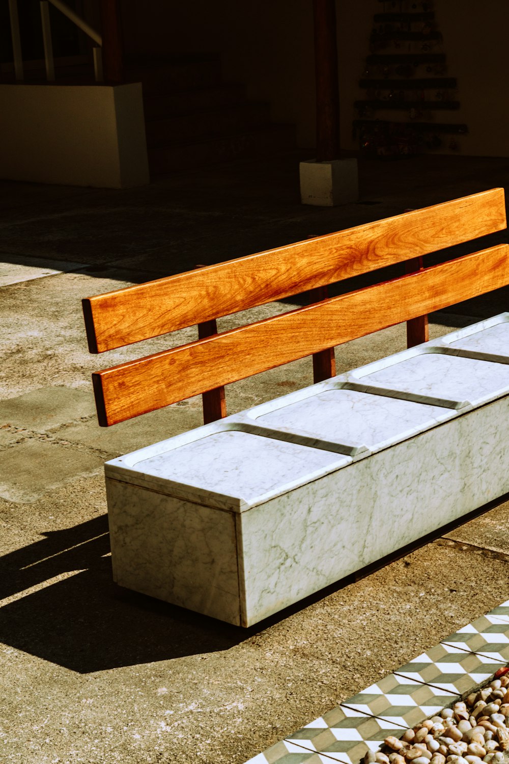 brown wooden bench on gray sand