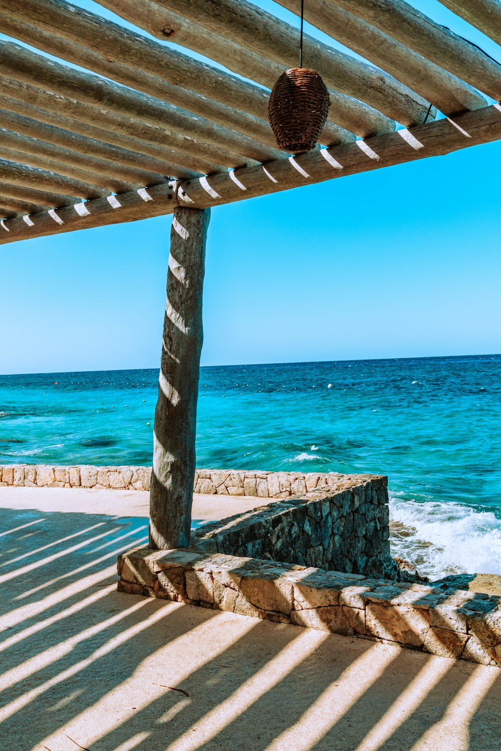 brown wooden dock on blue sea during daytime