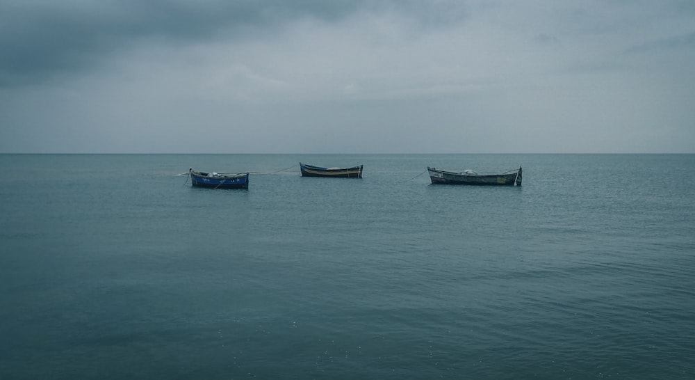 brown boat on sea under white sky during daytime