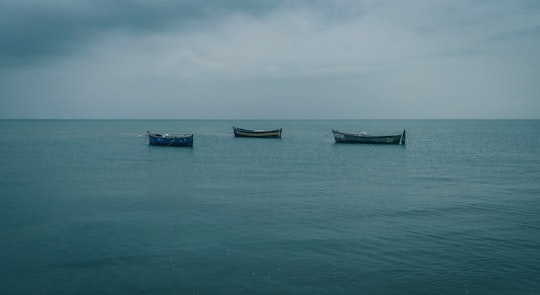 brown boat on sea under white sky during daytime in Malpe India