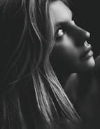 A digital portrait on a computer screen with soft gray and blue tones.