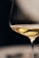 clear wine glass with yellow liquid