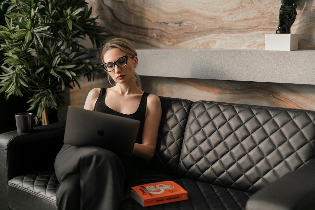 A woman using a laptop to explore natural language processing in corporate search functions.