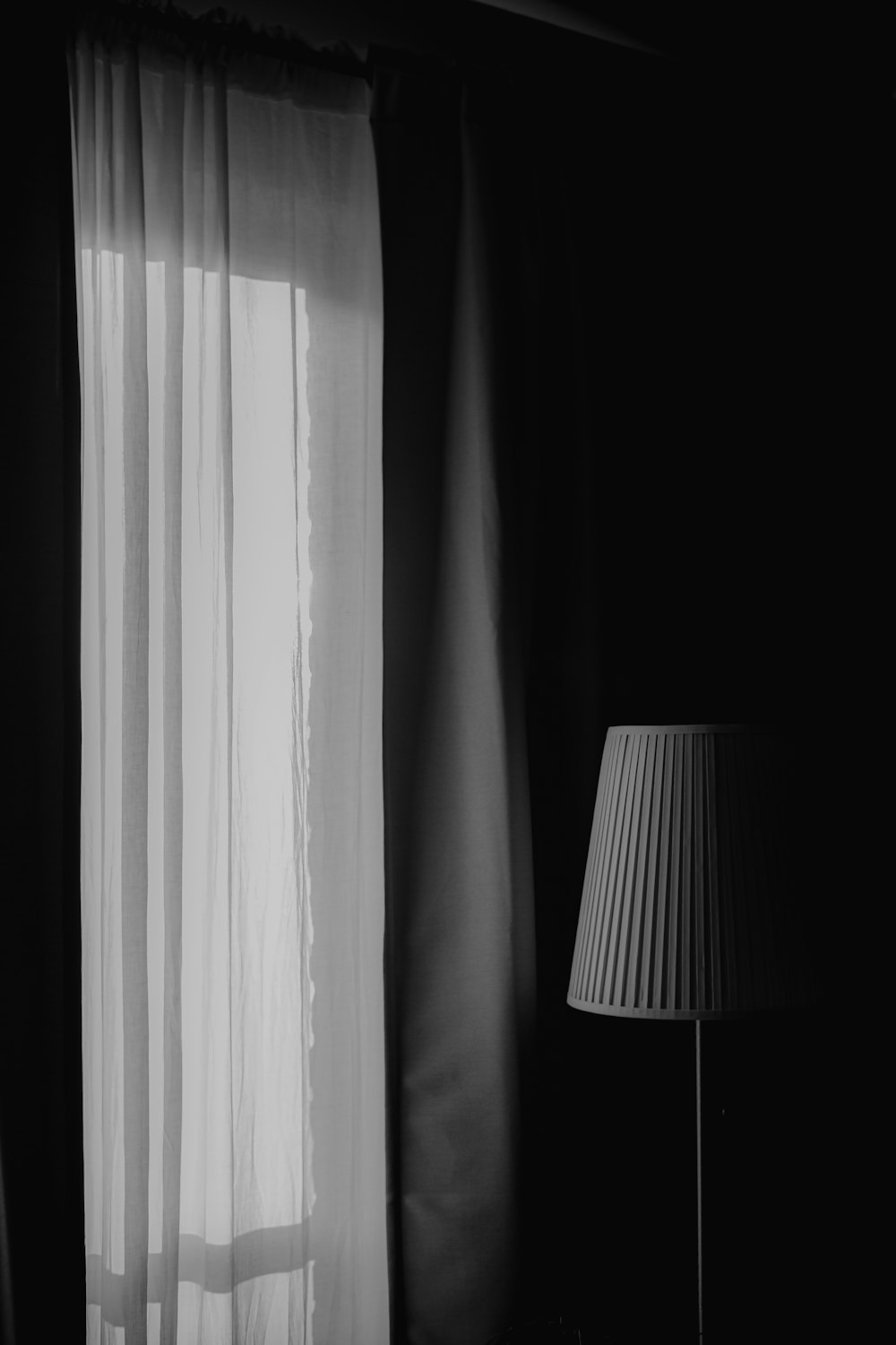 white table lamp beside white window curtain