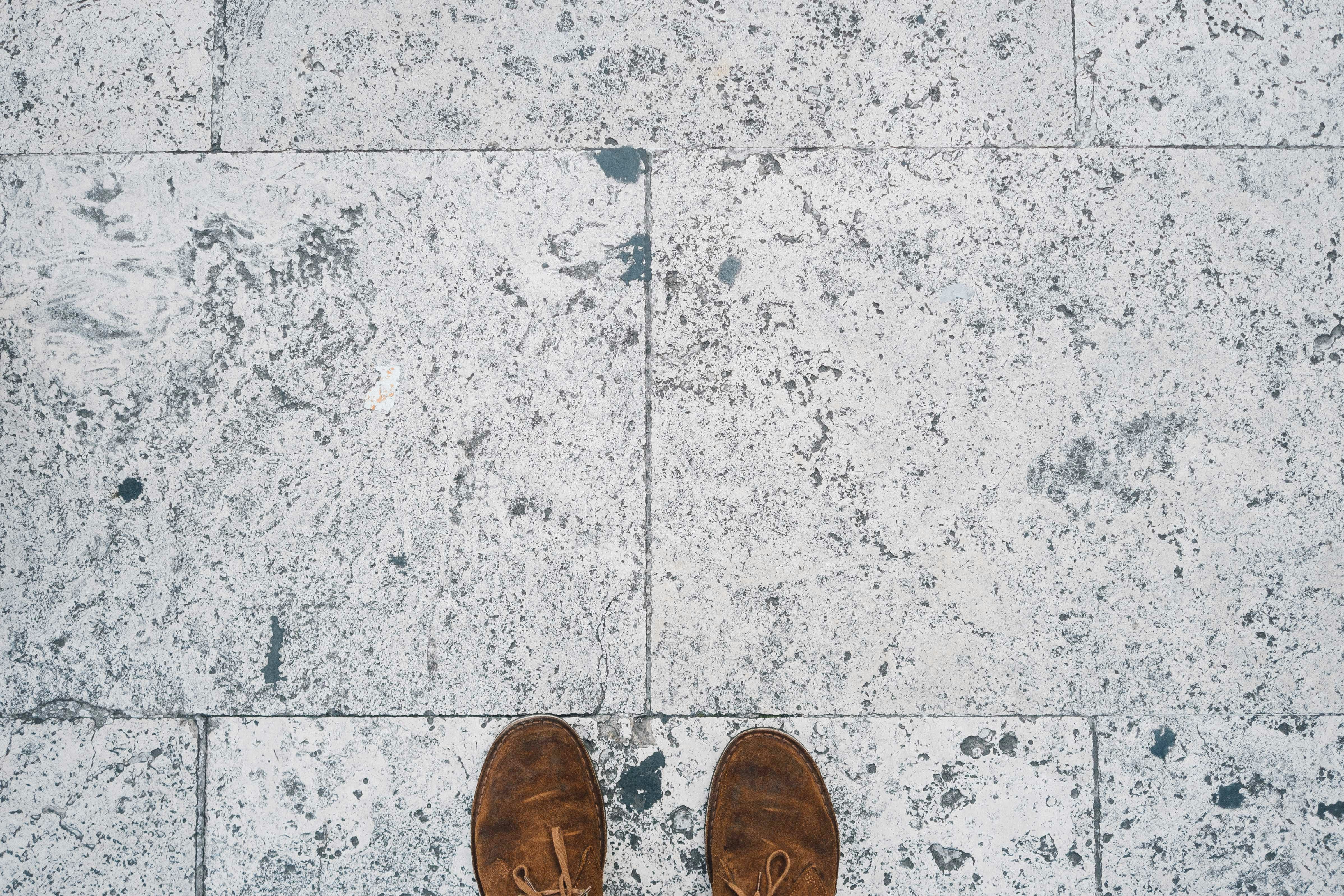 Feet on a marble floor, boots. Shoes