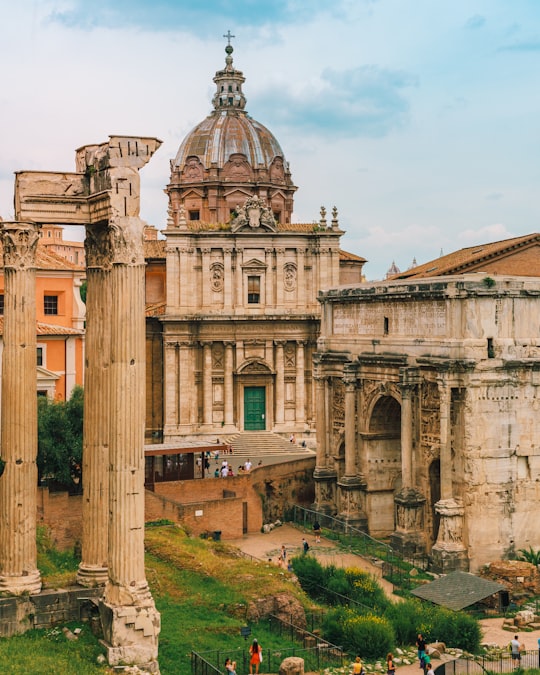 brown concrete building under blue sky during daytime in Roman Forum Italy