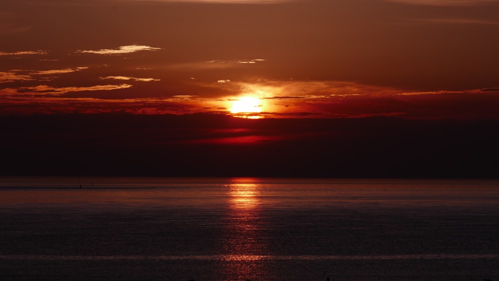 body of water during sunset