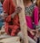 A diverse group of happy customers wearing stylish long clothing outdoors.