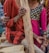 A diverse group of happy customers wearing stylish long clothing outdoors.