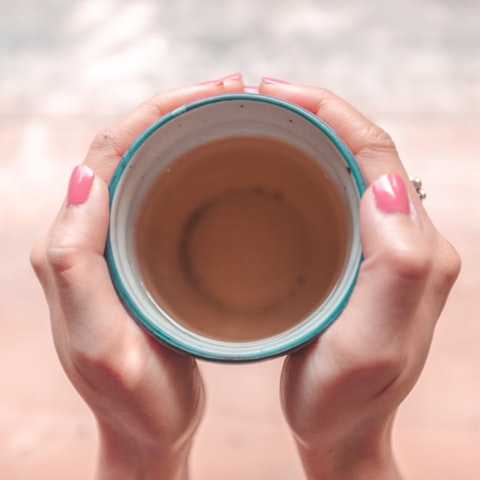 person relaxing with mug in hand