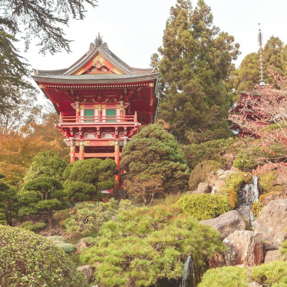 red and white temple on green moss covered rock