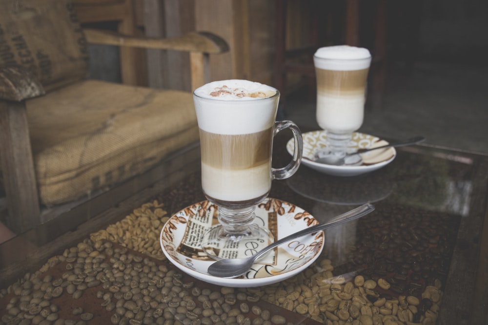 clear glass mug on white ceramic saucer