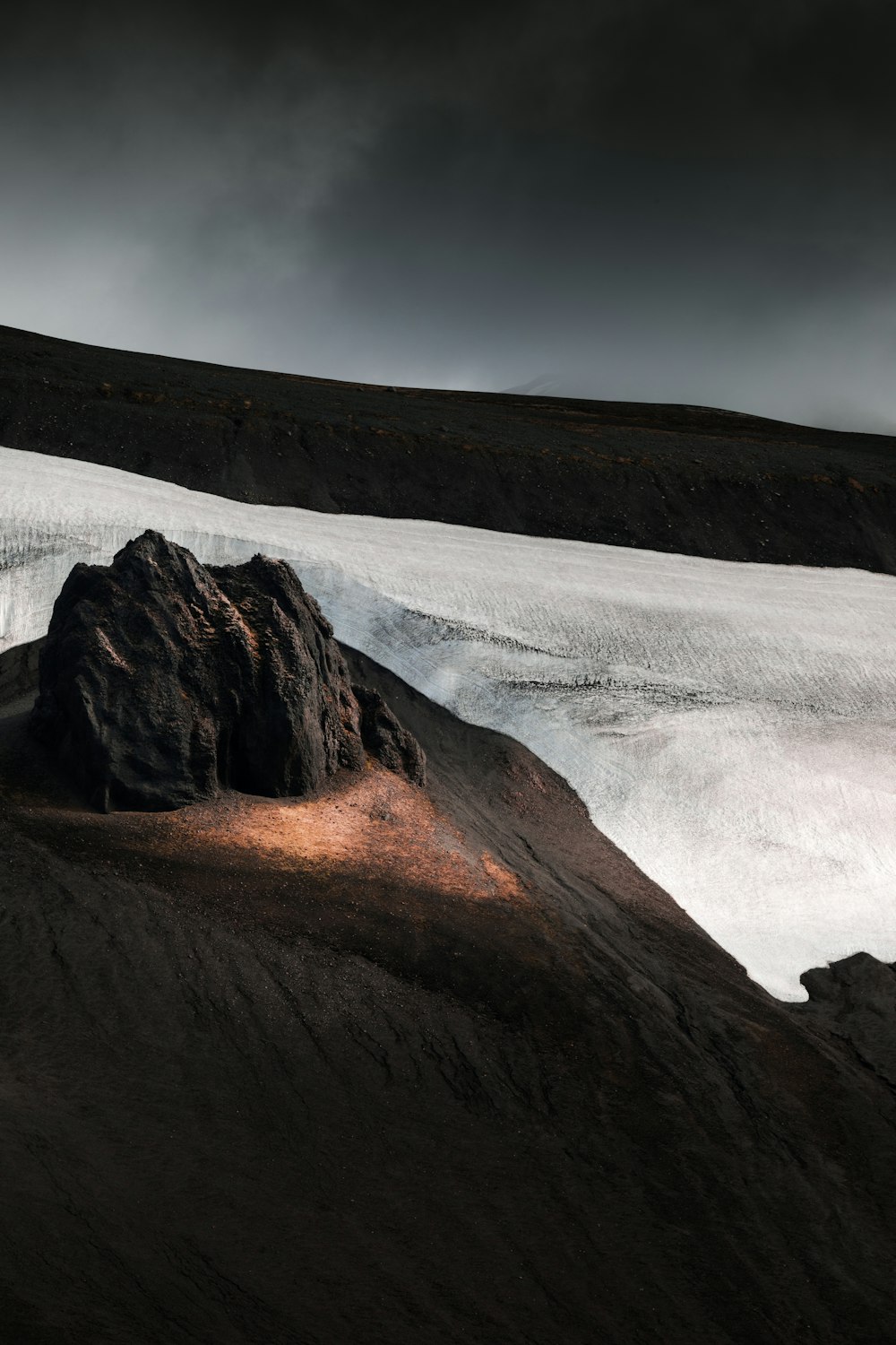 brown mountain under white clouds during daytime