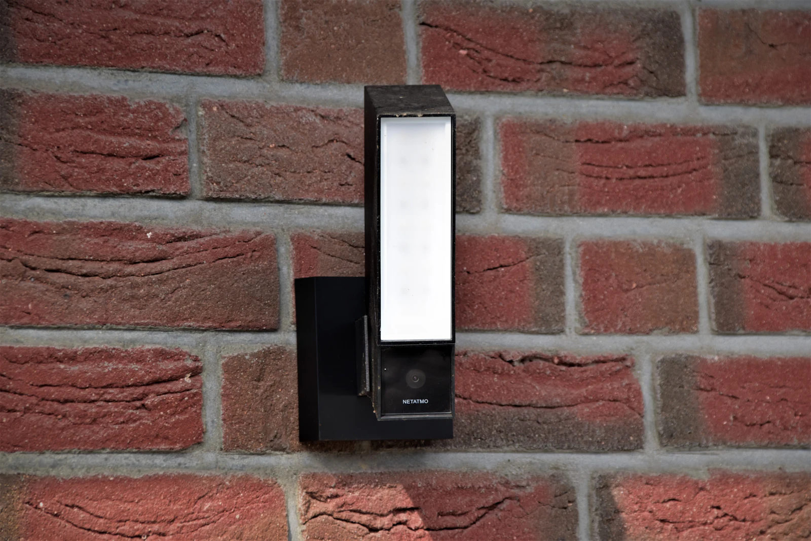 Outdoor camera light mounted on a brick wall
