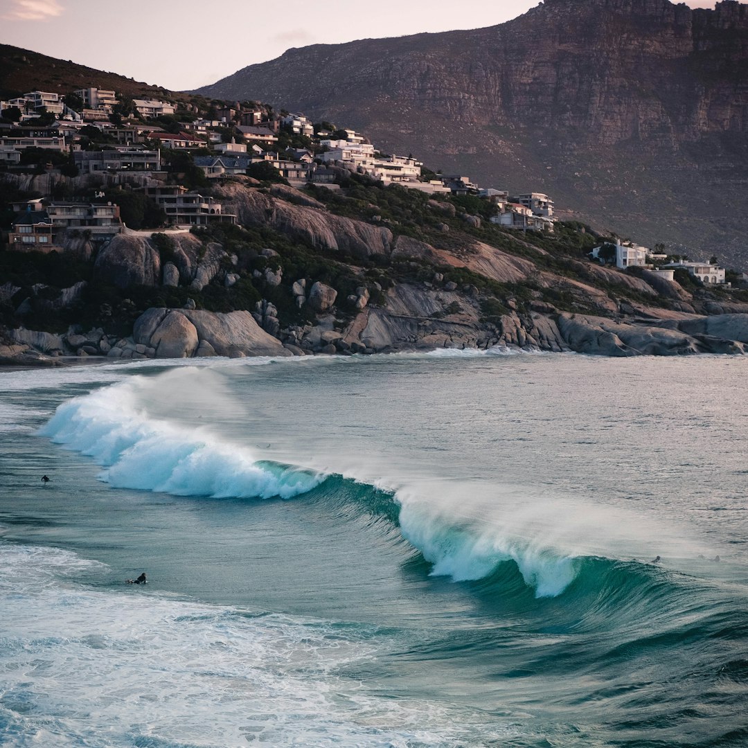 ocean waves crashing on rocky shore during daytime