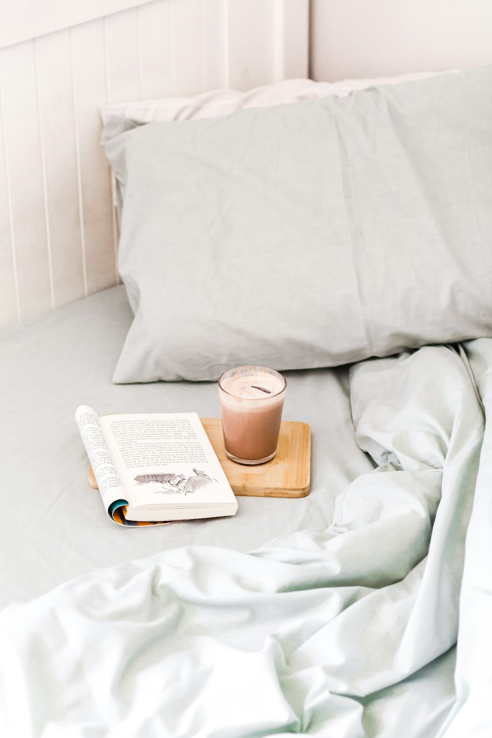white book on white bed