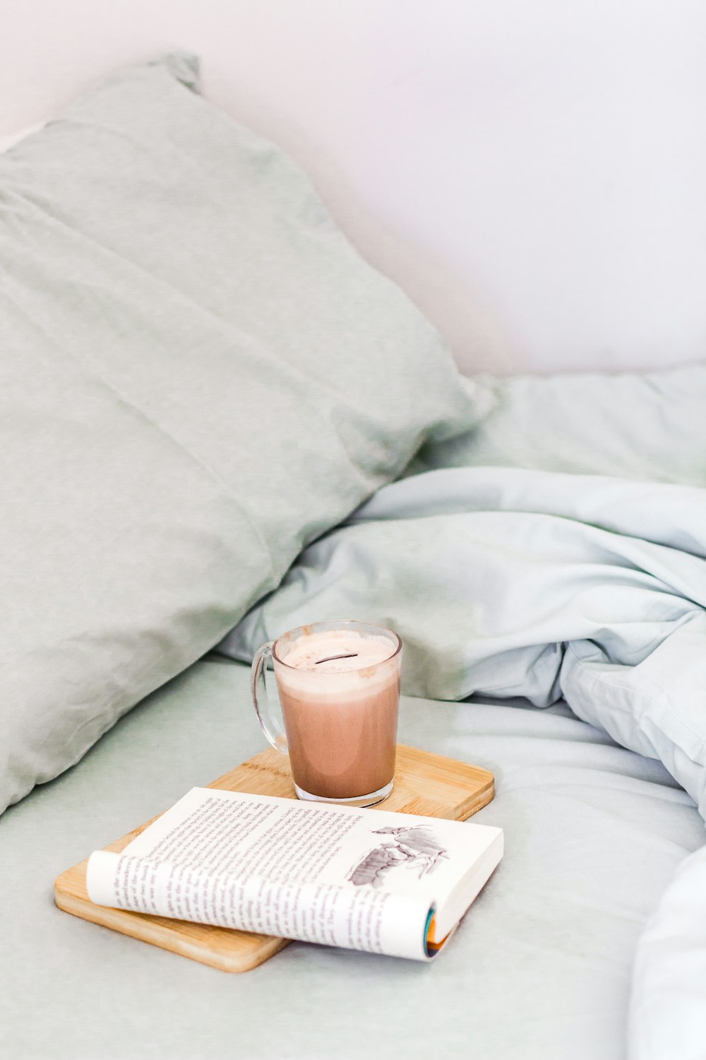 white ceramic mug on book