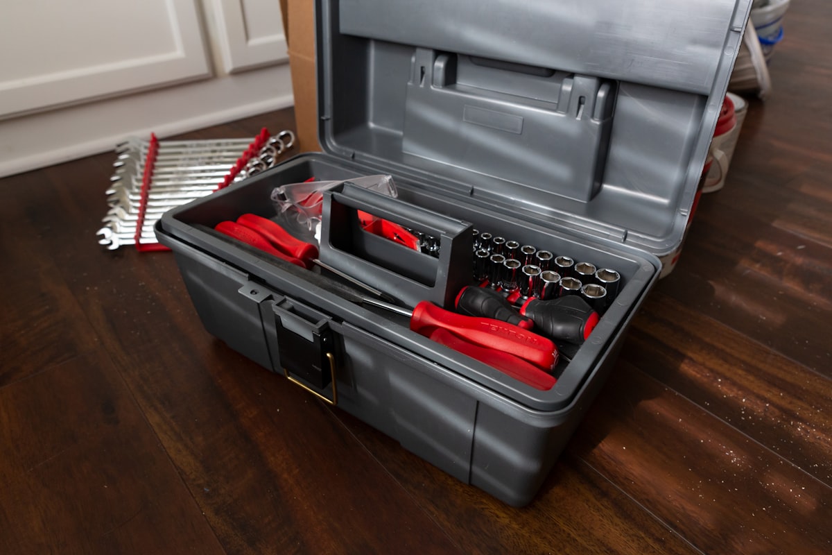 An open red and black toolbox on a workbench, representing the do-it-yourself approach to customer research
