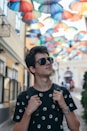 boy in black and white crew neck shirt wearing black sunglasses