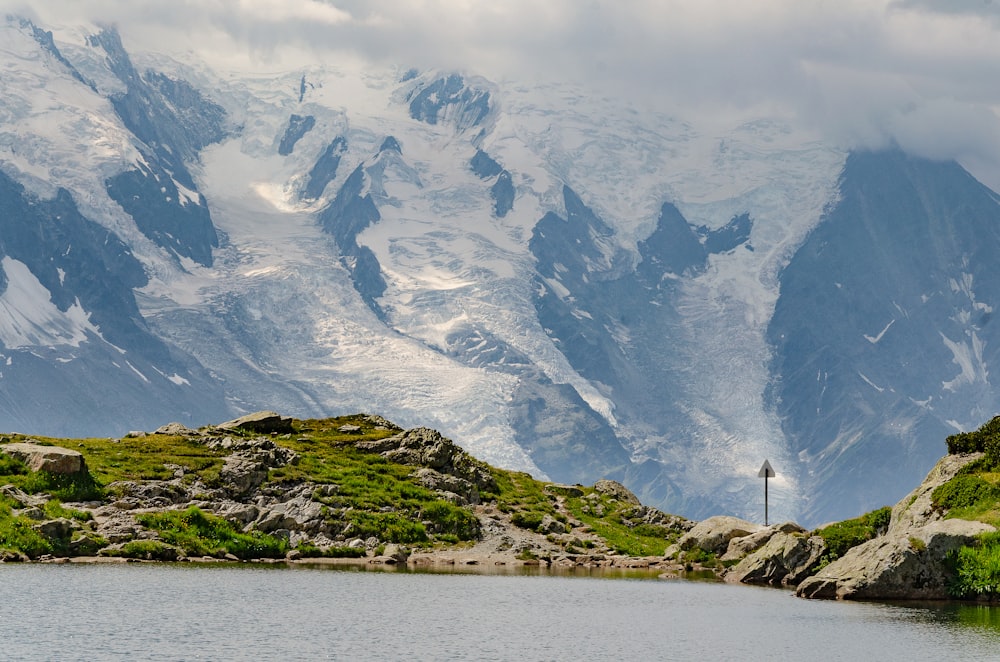 green and white mountains near body of water during daytime