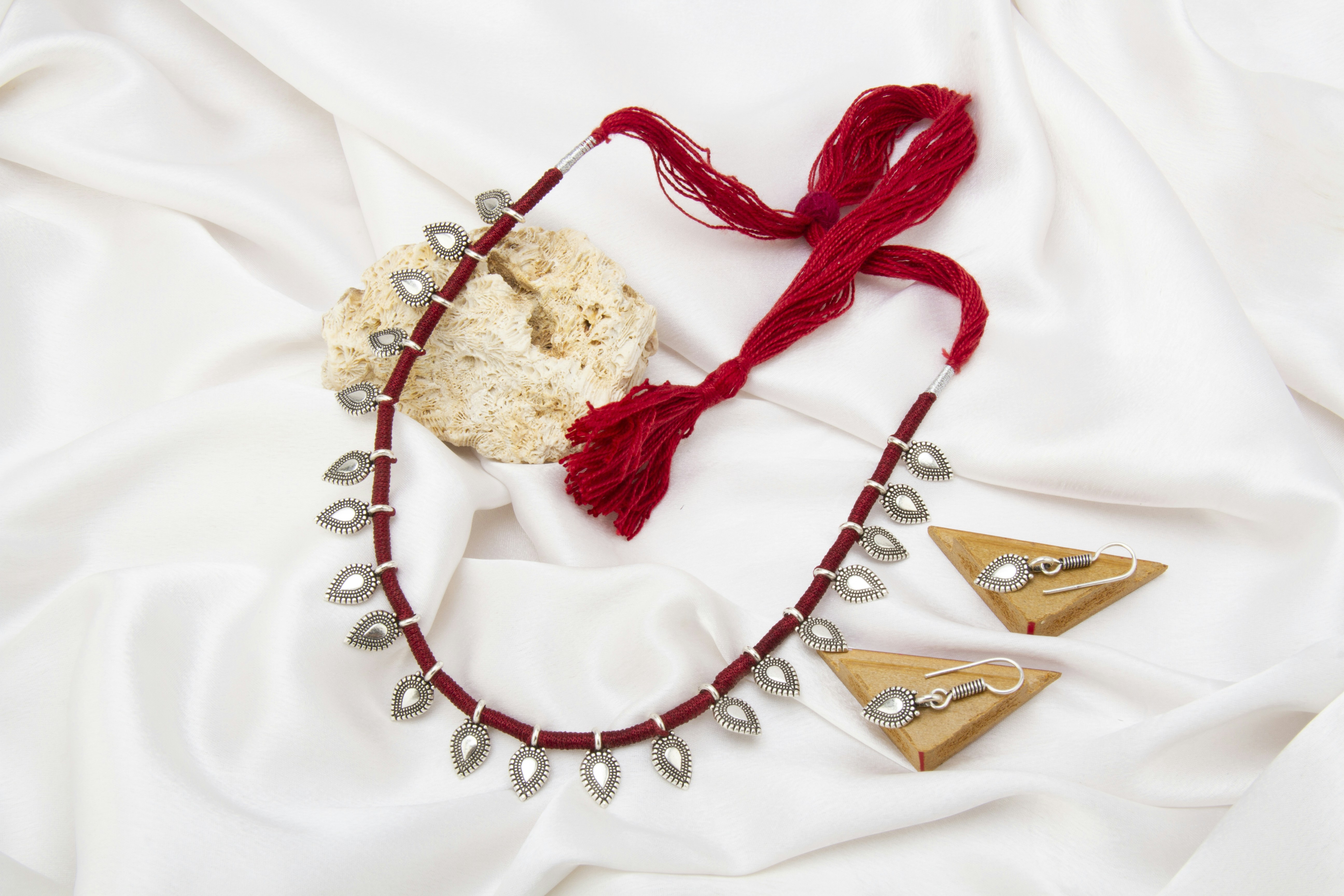 Sapphire and gold cascade necklace draped on white silk