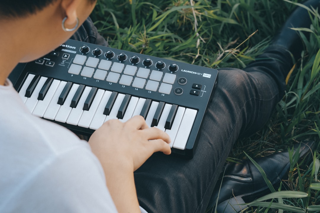 woman in black long sleeve shirt playing black and white electric keyboard