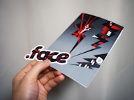 person holding gray and red box