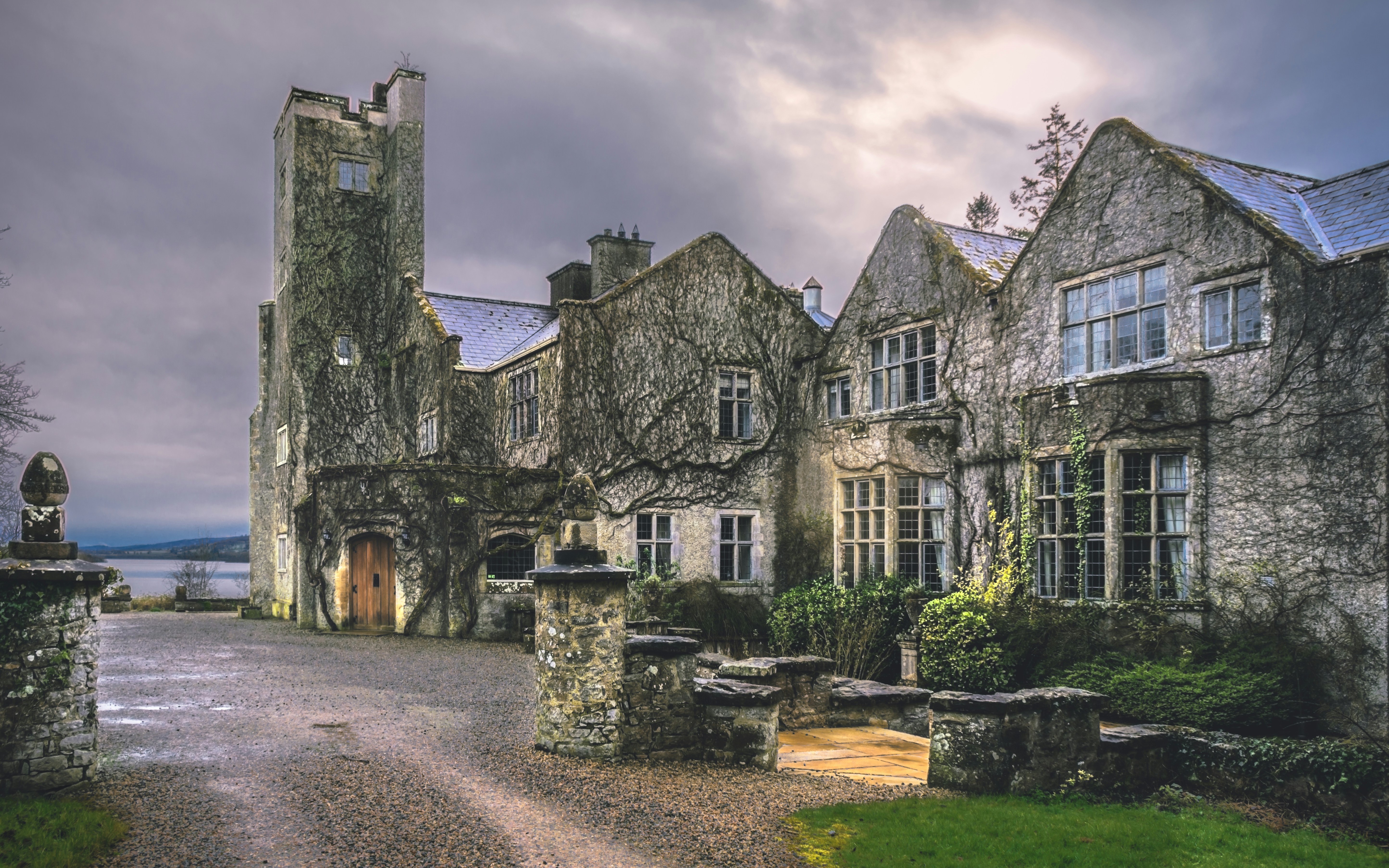 brown and gray concrete building under gray sky, A defoliated-ivy-clad Belle Isle Castle on Lough Erne during a brief respite from a fierce late winter/early spring storm.