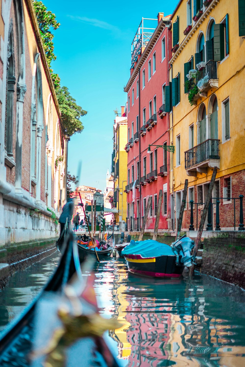 boat on river between buildings during daytime