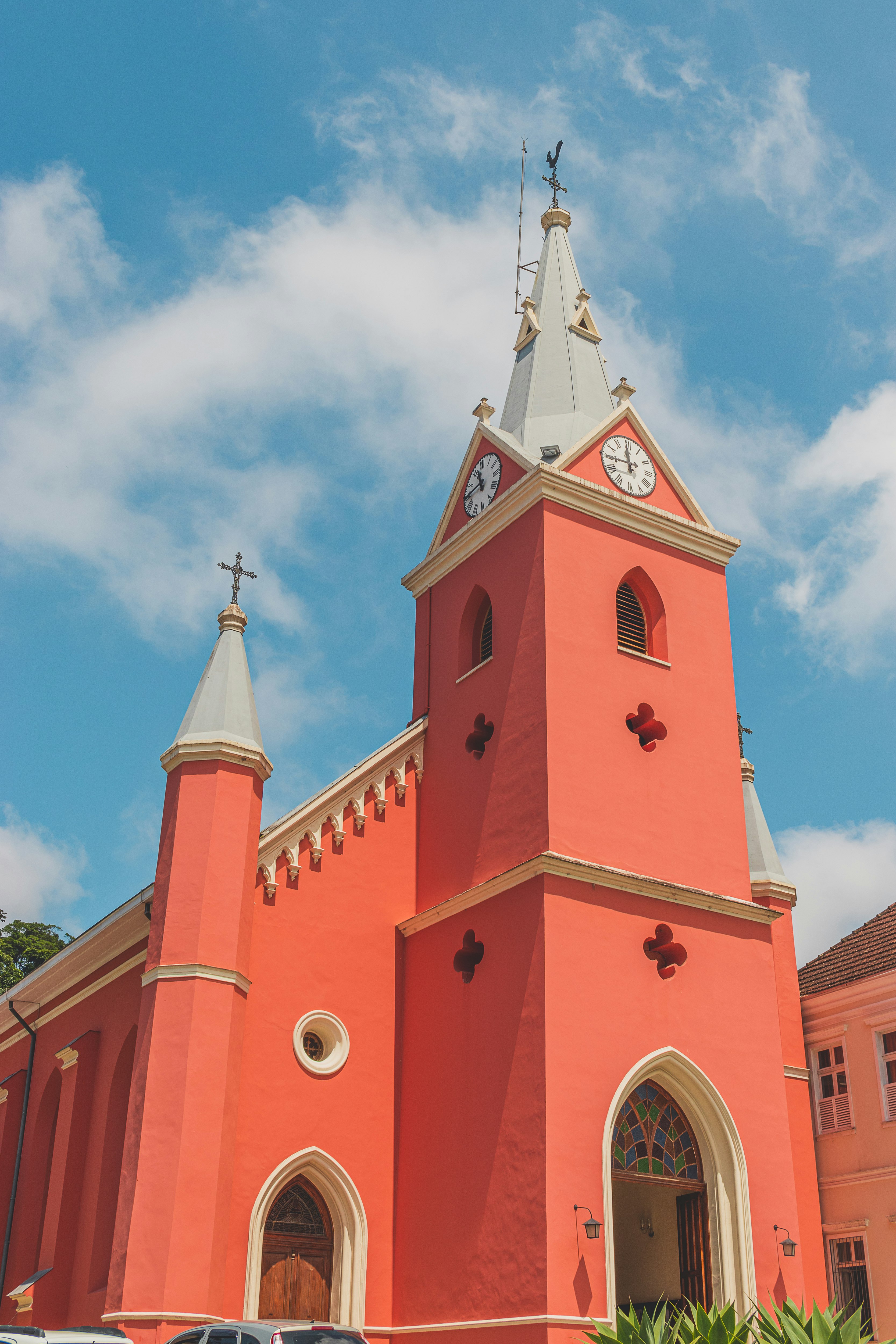 red and white concrete church under blue sky during daytime