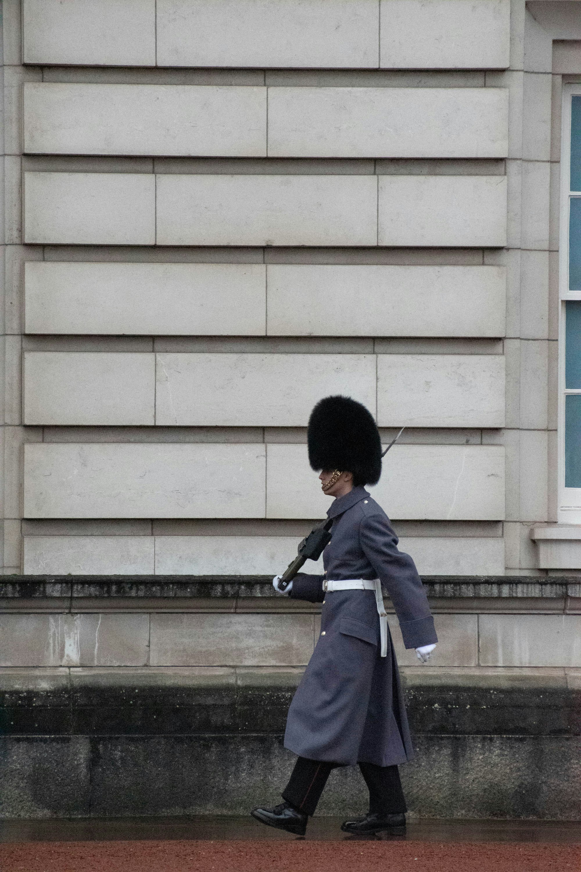 A guard walking on the sidewalk