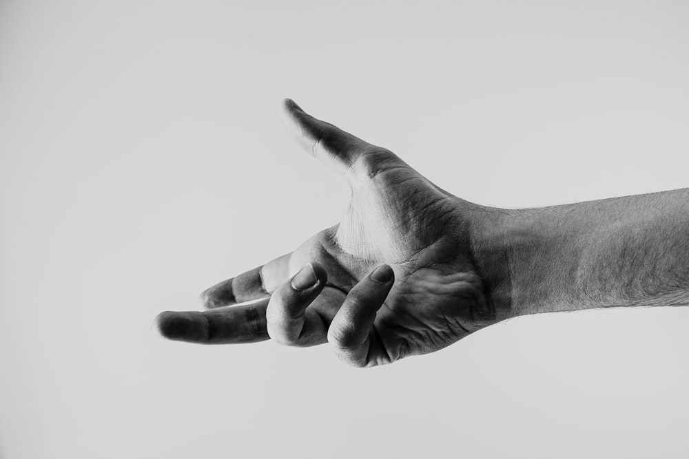 grayscale photo of persons hand