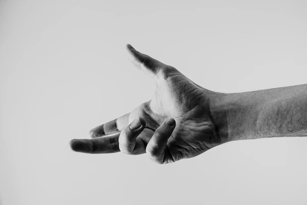 A hand gesturing, shown in grayscale