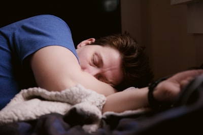 woman in blue shirt sleeping-subtitle-Prioritize Sleep-topic-How to Get Lean Mass Body