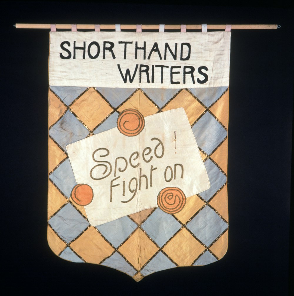 a banner hanging from a clothes line that says, shorthand writer speed fight on