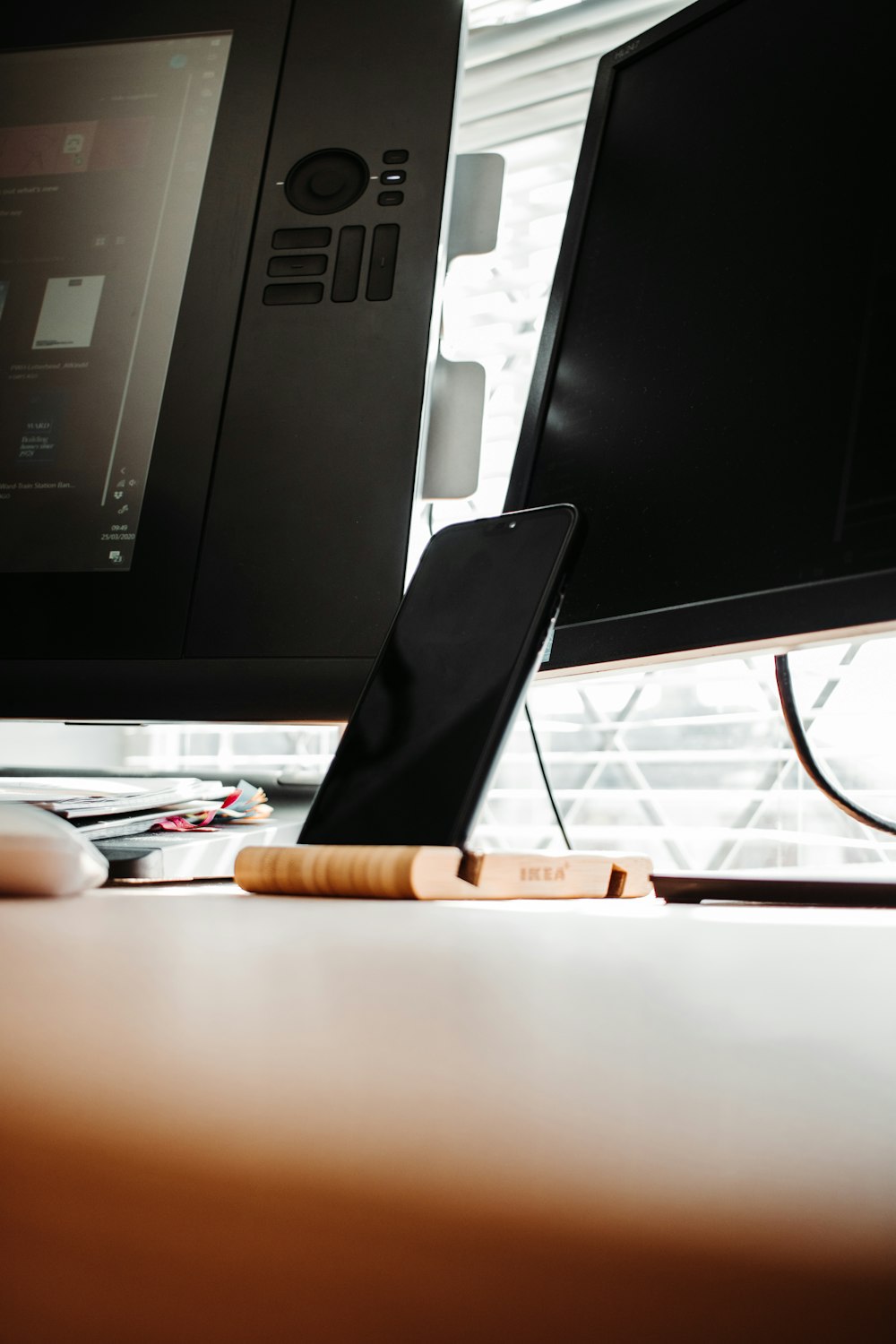 black and white smartphone on brown wooden table