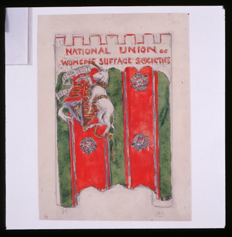 A banner featuring a medieval-style shield and coat of arms with a lion holding a flag. The banner has a red and green background, and the text at the top reads 'NATIONAL UNION OF WOMEN'S SUFFRAGE SOCIETIES.' The top edge of the banner is crenellated, resembling a castle wall.