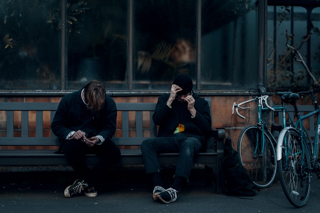 2 women sitting on bench