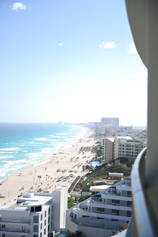 aerial view of city buildings near sea during daytime in Cancún Mexico