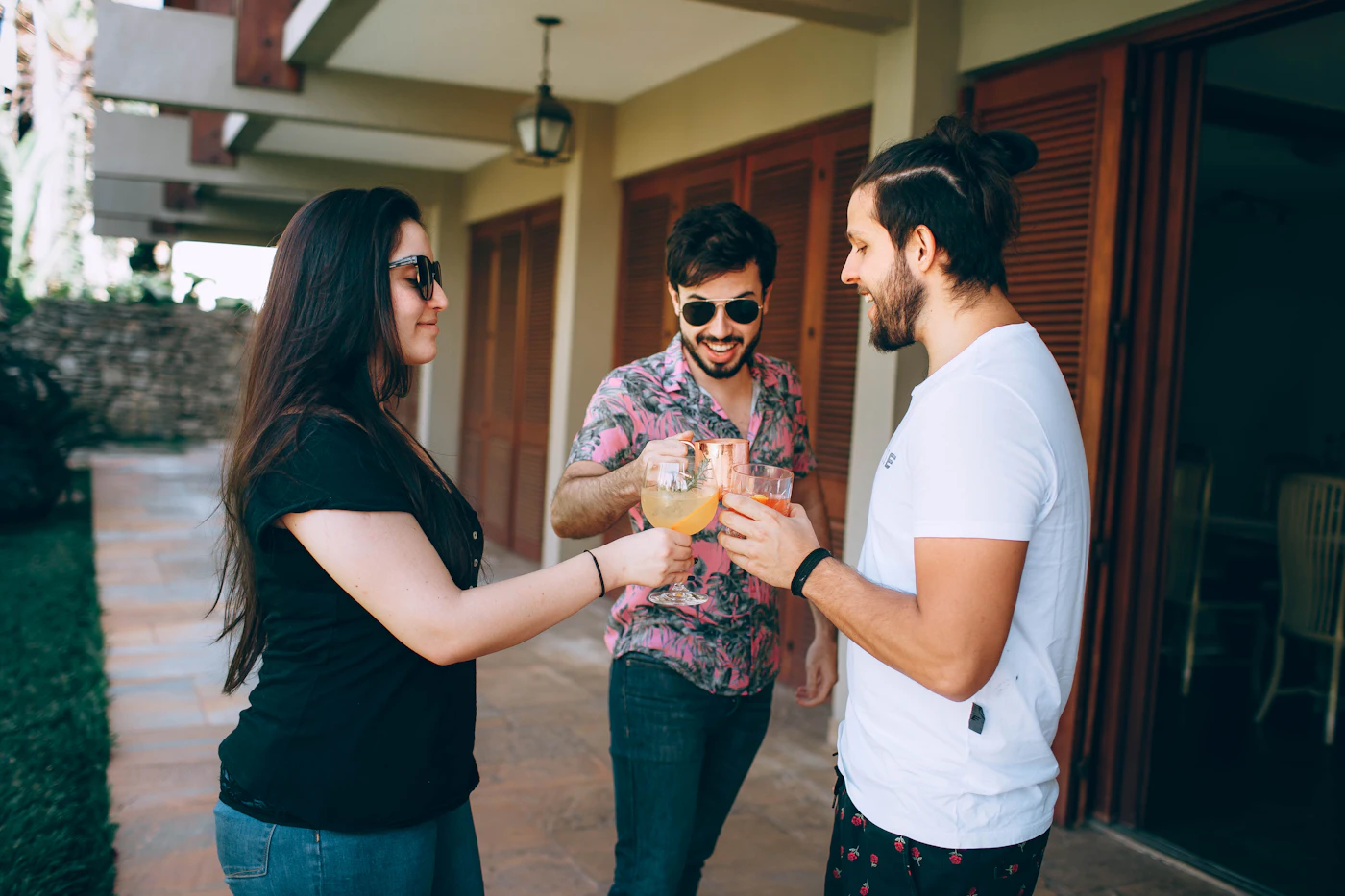 Friends celebrating together at the front door of a home