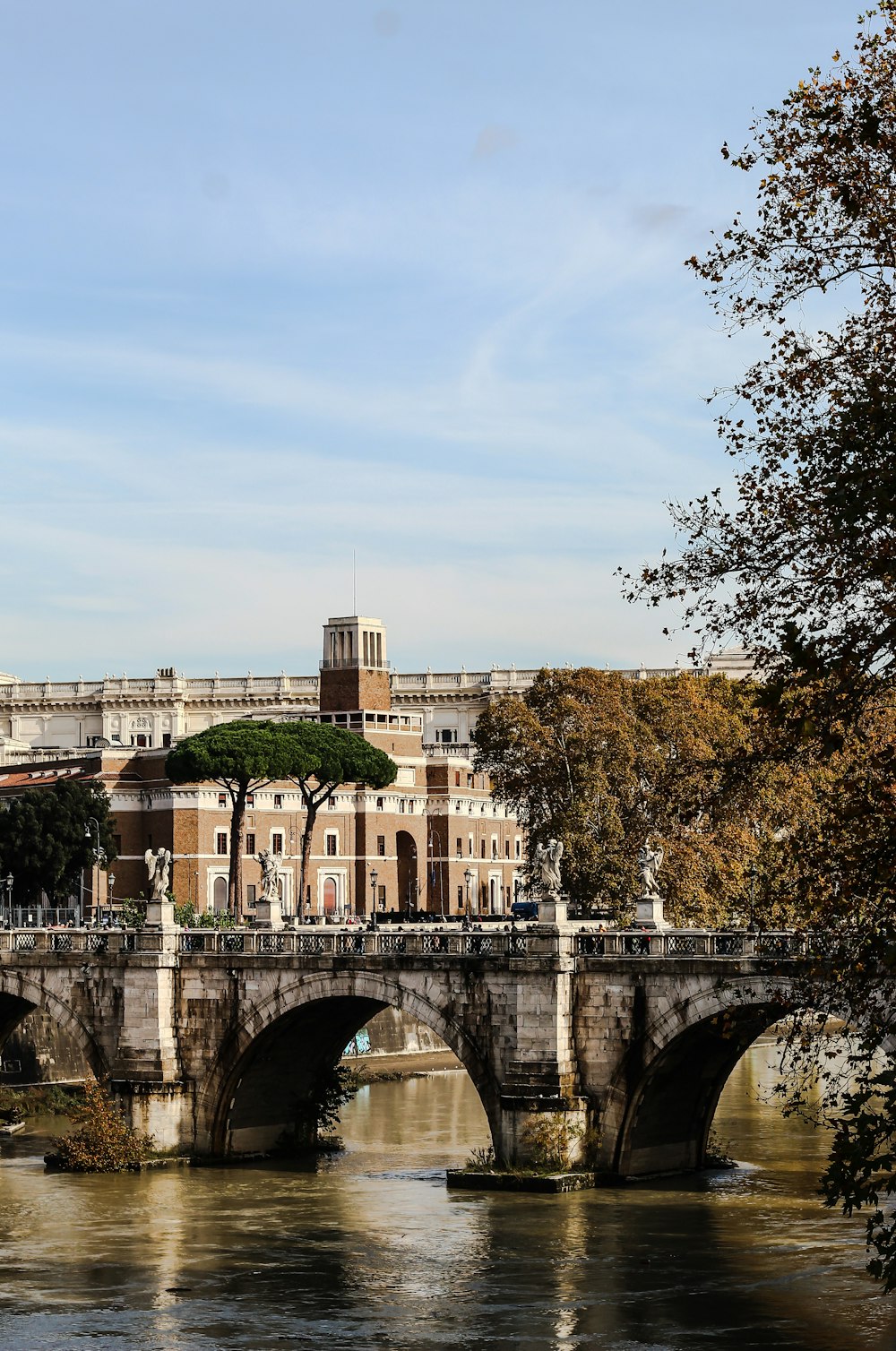 white concrete bridge near white concrete building during daytime