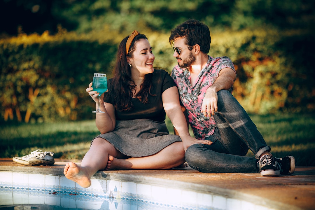 couple sitting on blue wooden bench during daytime